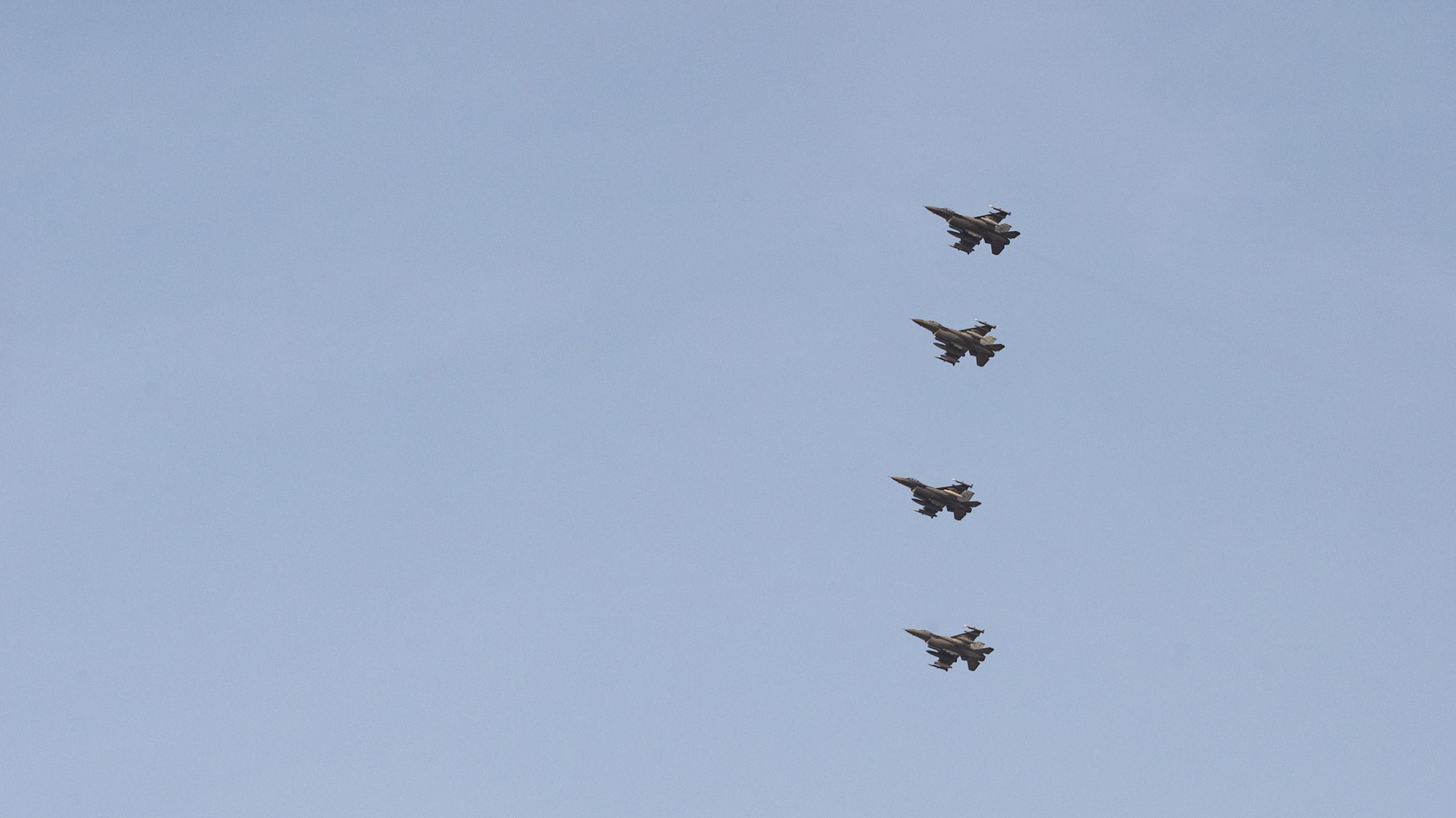 Four U.S. Air Force F-16C Fighting Falcons assigned to the 555th Expeditionary Fighter Squadron conduct an initial approach.