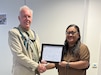 Bernard Jaye, the safety officer for Logistics Readiness Center Benelux, 405th Army Field Support Brigade, is presented with his Belgian Safety Certification Qualification Level II certificate from Diana Ioane, the director of LRC Benelux, at her office June 30, 2025. (U.S. Army courtesy photo)