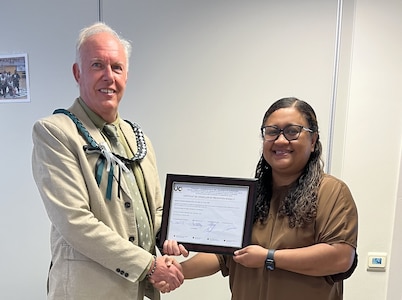 Bernard Jaye, the safety officer for Logistics Readiness Center Benelux, 405th Army Field Support Brigade, is presented with his Belgian Safety Certification Qualification Level II certificate from Diana Ioane, the director of LRC Benelux, at her office June 30, 2025. (U.S. Army courtesy photo)