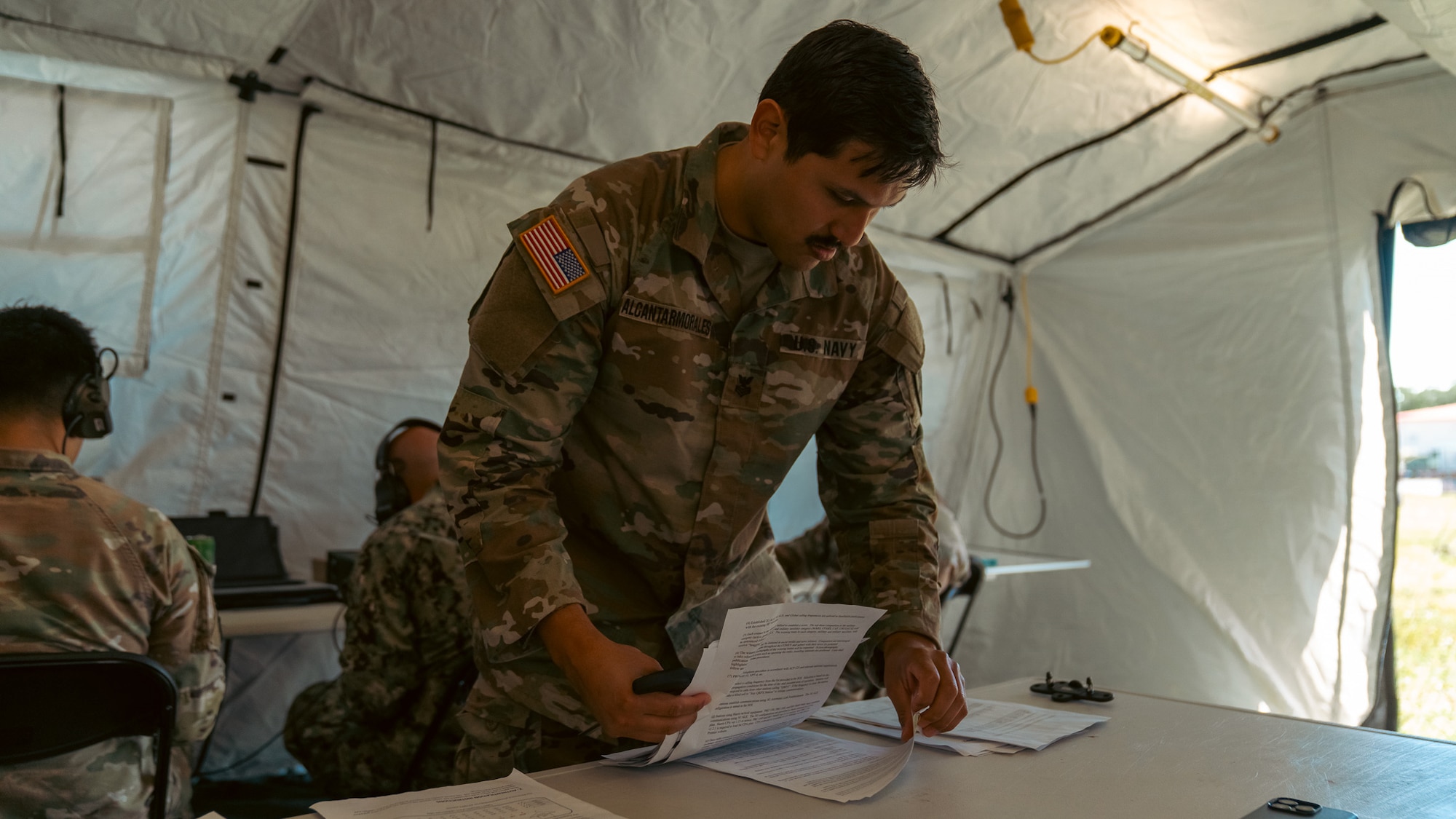 U.S. Navy Information Systems Technician Petty Officer 1st Class Roberto Alcantarmorales, 2nd Joint Communications Squadron, reviews operating instructions during the annual U.S. Army Network Enterprise Technology Command (NETCOM), open-source software defined radio (QPRX) High Frequency (HF) Radio Competition,  from March 20-22, 2025, at MacDill Air Force Base, Florida. The 2nd JCS, which falls under the Joint Communication Support Element, is a unit within the Department of Defense that provides quick response deployable teams, specializing in communication to support various missions. (U.S. Army photo)