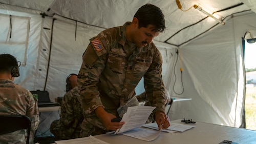 U.S. Navy Information Systems Technician Petty Officer 1st Class Roberto Alcantarmorales, 2nd Joint Communications Squadron, reviews operating instructions during the annual U.S. Army Network Enterprise Technology Command (NETCOM), open-source software defined radio (QPRX) High Frequency (HF) Radio Competition,  from March 20-22, 2025, at MacDill Air Force Base, Florida. The 2nd JCS, which falls under the Joint Communication Support Element, is a unit within the Department of Defense that provides quick response deployable teams, specializing in communication to support various missions. (U.S. Army photo)