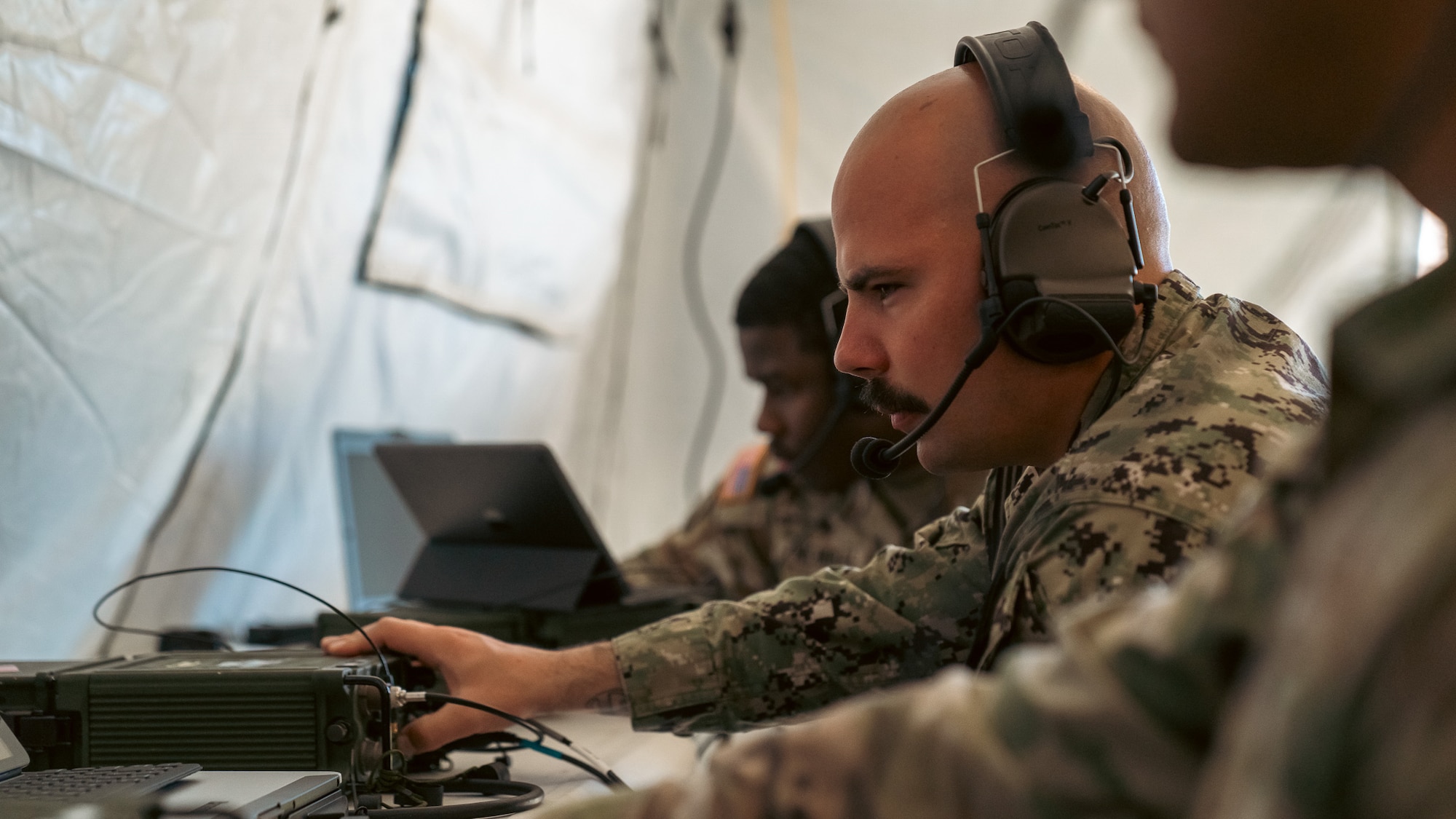 U.S. Navy Information Systems Technician Petty Officer 2nd Class Alex Coutler, 2nd Joint Communications Squadron Element, switches between fixed frequency radio channels during the annual United States Army Network Enterprise Technology Command (NETCOM), open-source software defined radio (QPRX) High Frequency (HF) Radio Competition, from March 20-22, 2025, at MacDill Air Force Base, Florida. The JCSE is a unit within the Department of Defense that provides quick response deployable teams, specializing in communication to support various missions. (U.S. Army photo)