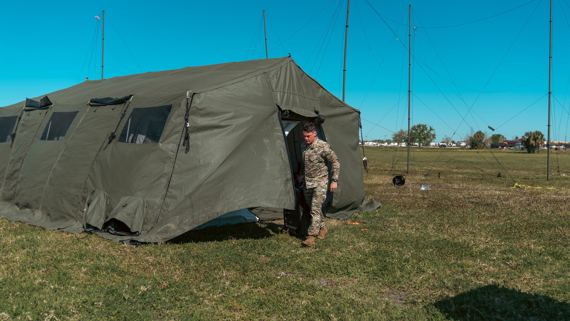 U.S. Army Staff Sgt. Patrick J. Cook, 2nd Joint Communications Squadron Element, joint communications systems technician, moves radio equipment during the annual U.S. Army Network Enterprise Technology Command, open-source software defined radio High Frequency Radio Competition, March 20-22, 2025, at MacDill Air Force Base, Florida. NETCOM QPRX HF 2025 Competition is a low power (20 Watts) competition sticking to a contest-based format with points awarded for achieving various criteria. JCSE provides quick response deployable teams, specializing in communication to support various missions. (U.S. Army photo)