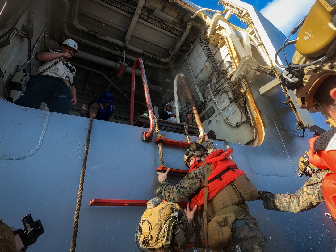U.S. Marines with Battalion Landing Team 3/6, 22nd Marine Expeditionary Unit (Special Operations Capable) board an 11-Meter Naval Special Warfare boat, during Composite Training Unit Exercise, while underway aboard the San Antonio-class amphibious transport dock ship USS San Antonio (LPD 17), Iwo Jima Amphibious Ready Group in the Atlantic Ocean, July 2, 2025. During COMPTUEX, the IWOARG and 22nd MEU (SOC), refine tactics, techniques, and procedures to execute warfighting functions that enhance operational readiness and lethality as a unified IWOARG/22 MEU (SOC) team. (U.S. Marine Corps photo by Sgt. Nathan Mitchell)