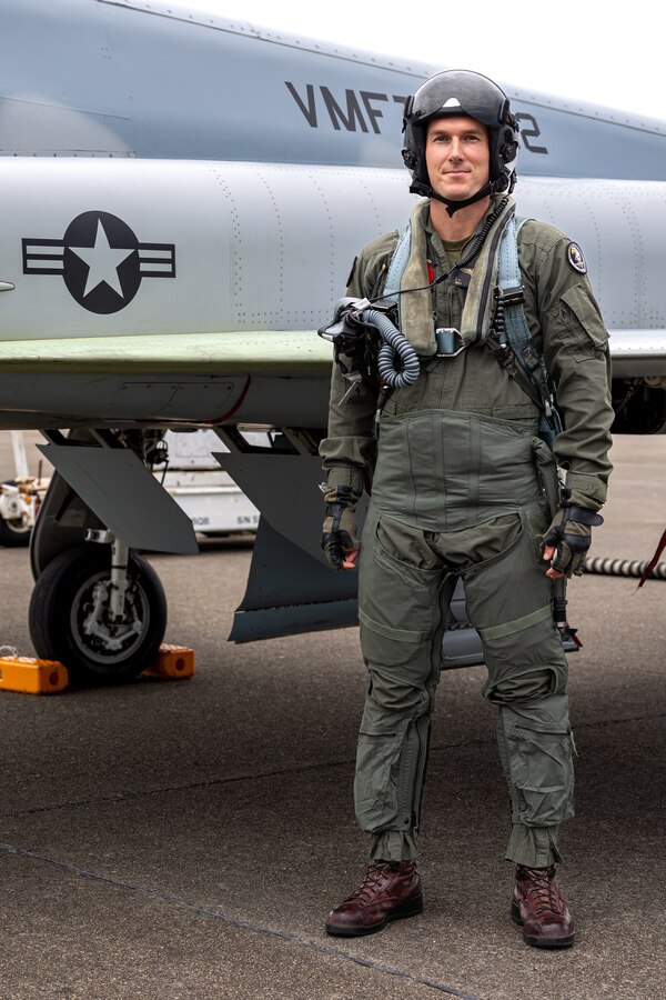 U.S. Marine Corps Maj. John J. Carter, an aircraft maintenance officer with Marine Fighter Training Squadron (VMFT) 402, poses in front of an F-5N Tiger II aircraft during Atlantic Alliance 2025 at Joint Base Cape Cod, Massachusetts, July 2, 2025. VMFT-402’s purpose in Atlantic Alliance is to support and enhance Navy-Marine Corps amphibious operations by providing advanced fighter training and integrating air combat capabilities into joint and allied exercises along the East Coast. (U.S. Marine Corps photo by Sgt. Emely Gonzalez)