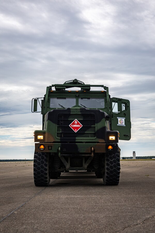 A U.S. Marine Corps Medium Tactical Vehicle Replacement provides fuel to the F-5N Tiger II aircraft assigned to Marine Fighter Training Squadron (VMFT) 402 during Atlantic Alliance 2025 at Joint Base Cape Cod, Massachusetts, July 2, 2025.  MWSS-471 delivers expeditionary refueling support to Marine Corps aircraft, enabling sustained aviation operations in different environments.  (U.S. Marine Corps photo by Sgt. Emely Gonzalez)