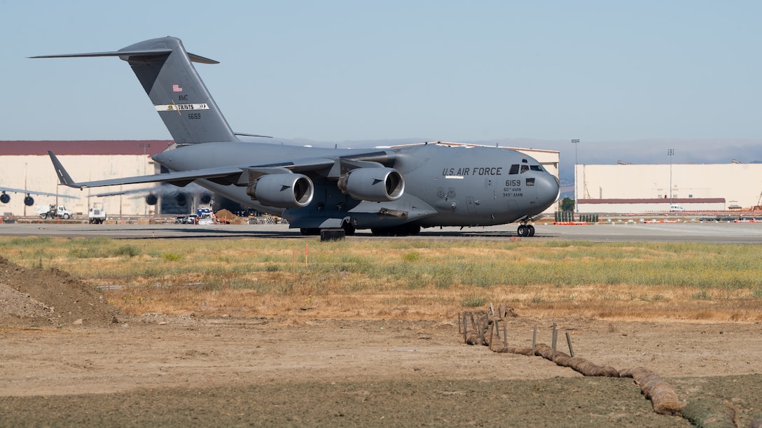 A U.S. Air Force C-17 Globemaster III assigned to the 21st Airlift Squadron taxis on the flight line during a final flight for Col. Steven Byrum, 60th Air Mobility Wing deputy commander, at Travis Air Force Base, California.