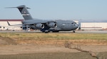 A U.S. Air Force C-17 Globemaster III assigned to the 21st Airlift Squadron taxis on the flight line during a final flight for Col. Steven Byrum, 60th Air Mobility Wing deputy commander, at Travis Air Force Base, California.