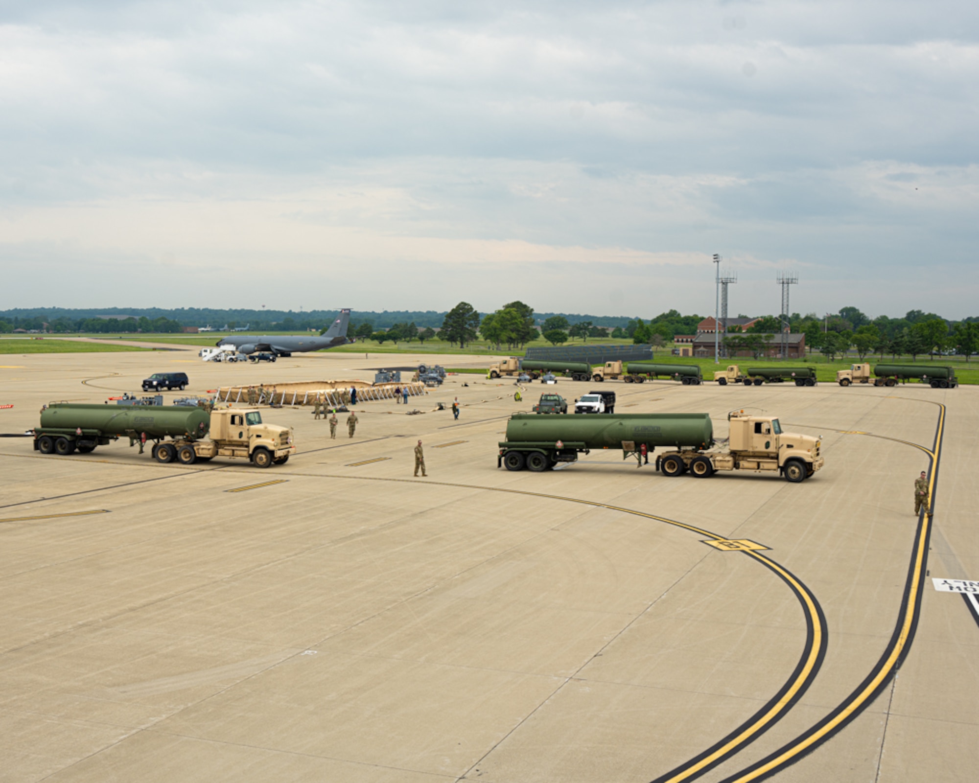 Fuel trucks surround ground refueling equipment