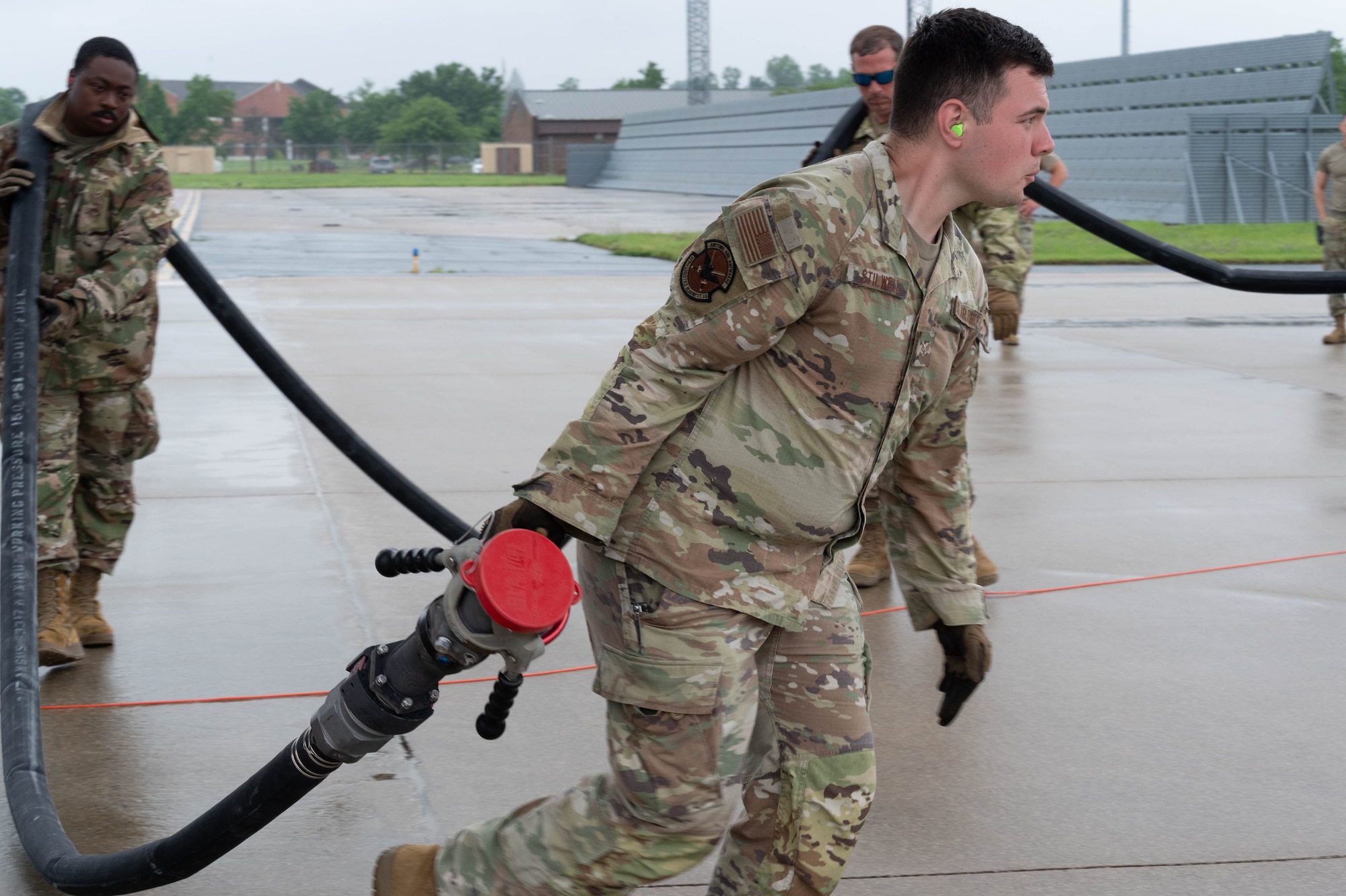 932nd Maintenance Group crew chiefs and the 375th Logistics Readiness Squadron personnel drag a fuel line during the Quartermaster Liquid Logistics Exercise (QLLEX) at Scott Air Force Base, Illinois, June 6, 2025. The QLLEX focused on giving Airmen valuable joint operations refueling training with active duty Air Force, U.S. Army Reserve, and Air National Guard personnel and resources. (U.S. photo by Tech. Sgt. Kari Siltz)