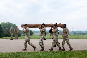 FORT RILEY, Kan. – Soldiers take part in the Best Squad Competition at Fort Riley on May 28, 2025. The event began with a physical training test that included a log carry, deadlifts, a run and a sled drag, designed to assess participants' strength, endurance and teamwork.(U.S. Army photos by Spc. Autumn Johnson)