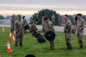 FORT RILEY, Kan. – Soldiers take part in the Best Squad Competition at Fort Riley on May 28, 2025. The event began with a physical training test that included a log carry, deadlifts, a run and a sled drag, designed to assess participants' strength, endurance and teamwork.(U.S. Army photos by Spc. Autumn Johnson)