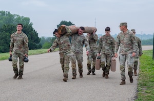 FORT RILEY, Kan. – Soldiers take part in the Best Squad Competition at Fort Riley on May 28, 2025. The event began with a physical training test that included a log carry, deadlifts, a run and a sled drag, designed to assess participants' strength, endurance and teamwork.(U.S. Army photos by Spc. Autumn Johnson)