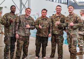 FORT RILEY, Kan. – Soldiers participate in a water survival test during the Best Squad Competition at Fort Riley on May 30, 2025. The assessment included swimming while holding an M4 rifle, along with exercises such as pushups, overhead claps and lunges performed while maintaining control of the weapon. The event tested participants’ physical readiness, mental toughness and ability to operate in challenging aquatic conditions.(U.S. Army photos by Spc. Autumn Johnson)