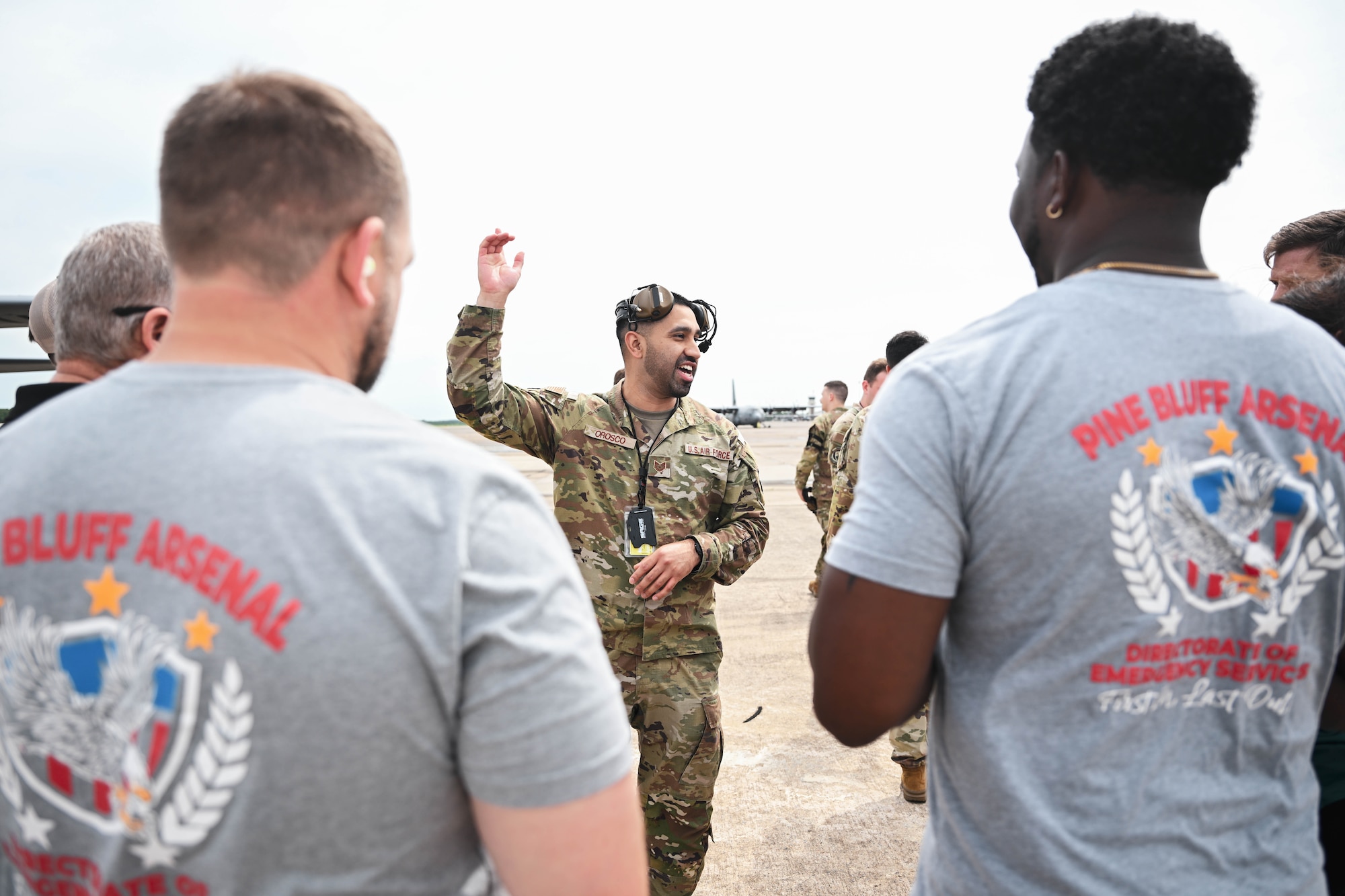 A man in uniform speaks with civilians.