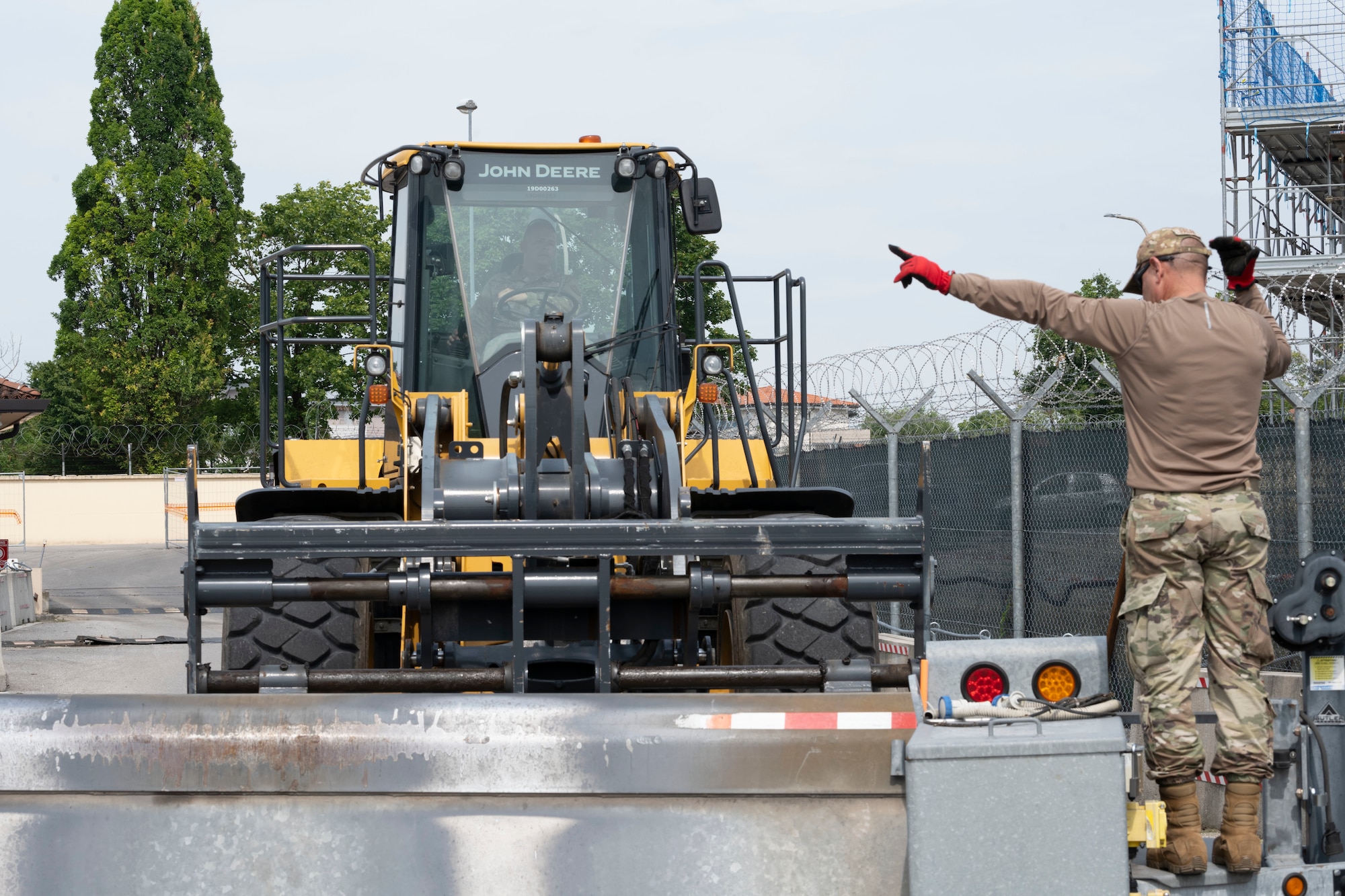 U.S. Air Force Tech. Sgt. Manuelyne Pagan, a pavement and construction craftsman assigned to the 156th Civil Engineer Squadron, Puerto Rico Air National Guard, directs a forklift during a Deployment for Training (DFT) at Aviano Air Base, Italy, June 17, 2025. During the DFT, the 156th CES developed their skill proficiency in a new area of responsibility while supporting real-world projects that support the U.S. European Command operations. (U.S. Air National Guard photo by Senior Airman Victoria Jewett)