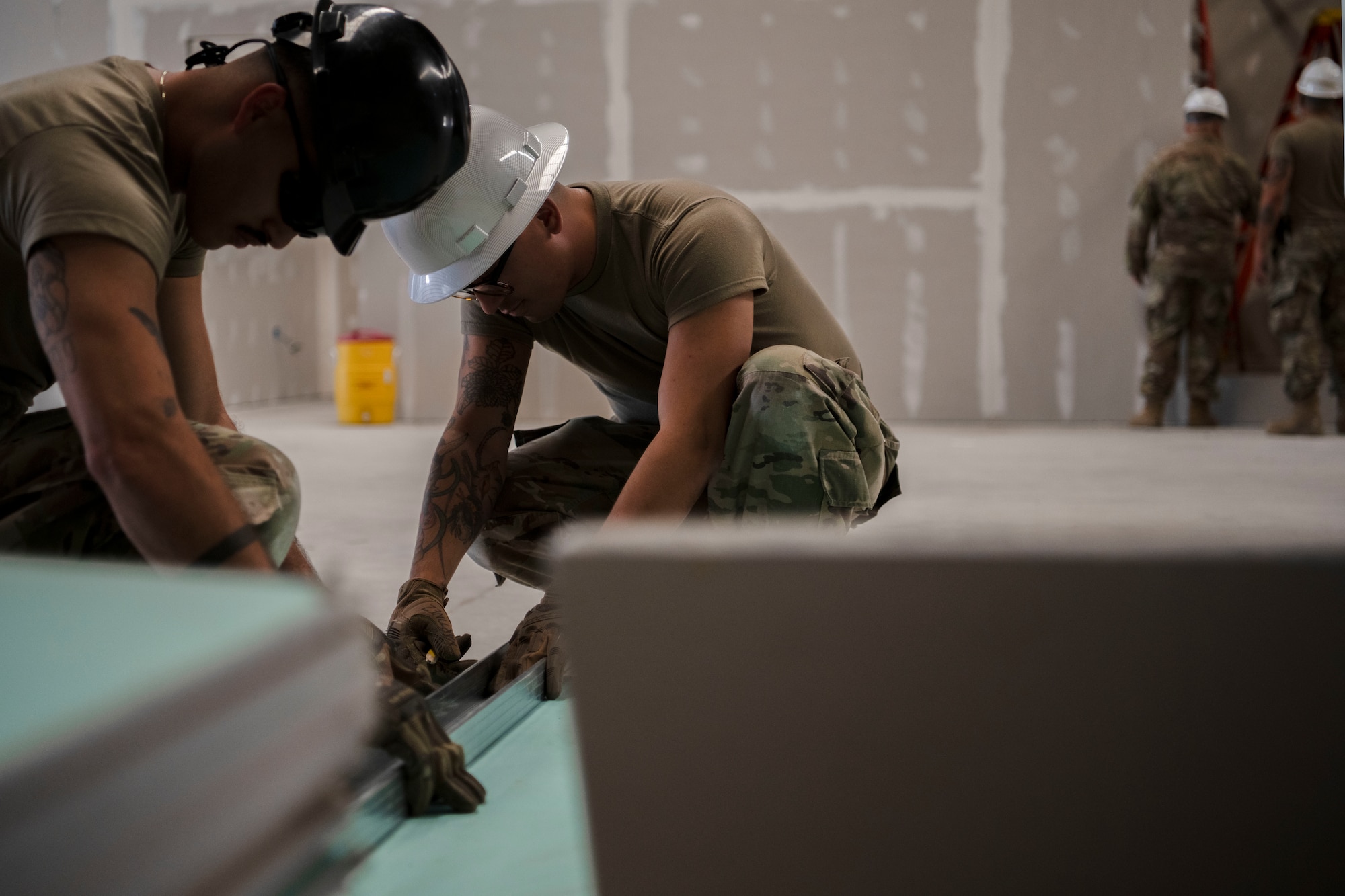 From left, U.S. Air Force Senior Airman Wilfredo Ortega and Staff Sgt. Jorge Martinez, both structural journeymen assigned to the 156th Civil Engineer Squadron, Puerto Rico Air National Guard, cut a gypsum board panel during a Deployment for Training (DFT) at Aviano Air Base, Italy, June 17, 2025. During the DFT, the 156th CES developed their skill proficiency in a new area of responsibility while supporting real-world projects that support the U.S. European Command operations. (U.S. Air National Guard photo by Senior Airman Victoria Jewett)