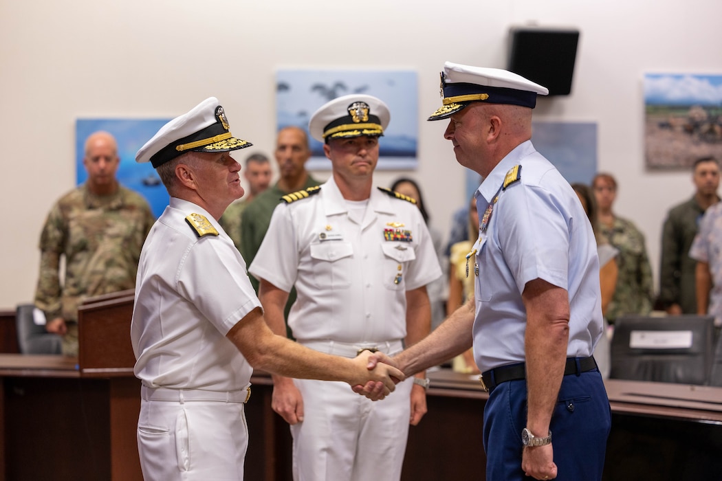Adm. Samuel J. Paparo, commander of U.S. Indo-Pacific Command, thanks Rear Adm. Bob Little for his leadership as he relinquishes command of Joint Interagency Task Force-West to Capt. George Howell. (Photo by Chelsey Kaneshiro)