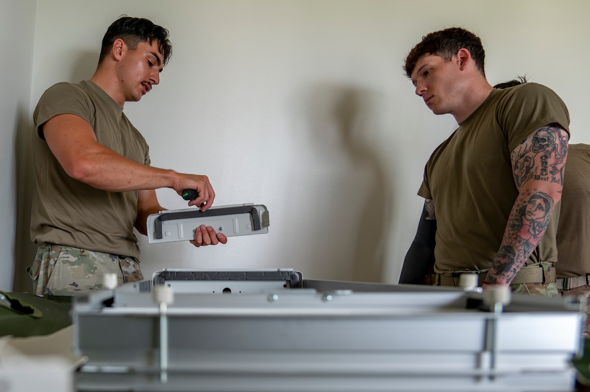 U.S. Air Force Airmen assigned to the 35th Fighter Wing (FW) prepare a portable air conditioning unit frame that will be installed in a contingency dormitory for Exercise Resolute Force Pacific (REFORPAC) at Misawa Air Base, Japan, July 2, 2025. This infrastructure upgrade will support a surge of more than 1,000 inbound service members for REFORPAC, enabling the 35th FW to maintain mission readiness under high-tempo conditions. (U.S. Air Force photo by Senior Airman Brittany Russell)