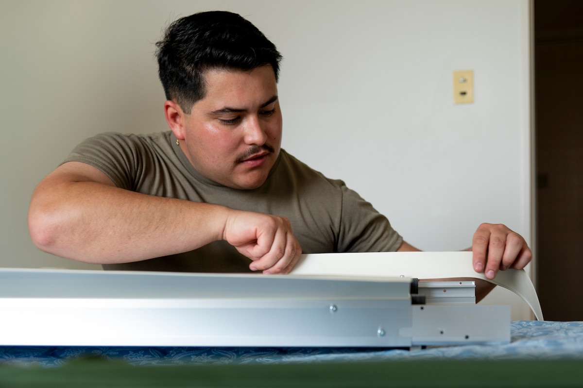 A U.S. Air Force Airman assigned to the 35th Fighter Wing (FW) assembles a portable air conditioning unit to be installed in a contingency dormitory for Exercise Resolute Force Pacific (REFORPAC) at Misawa Air Base, Japan, July 2, 2025. Airmen from across the wing came together to improve base infrastructure for REFORPAC, showcasing a unified commitment to readiness and mission success across the 35th FW. (U.S. Air Force photo by Senior Airman Brittany Russell)