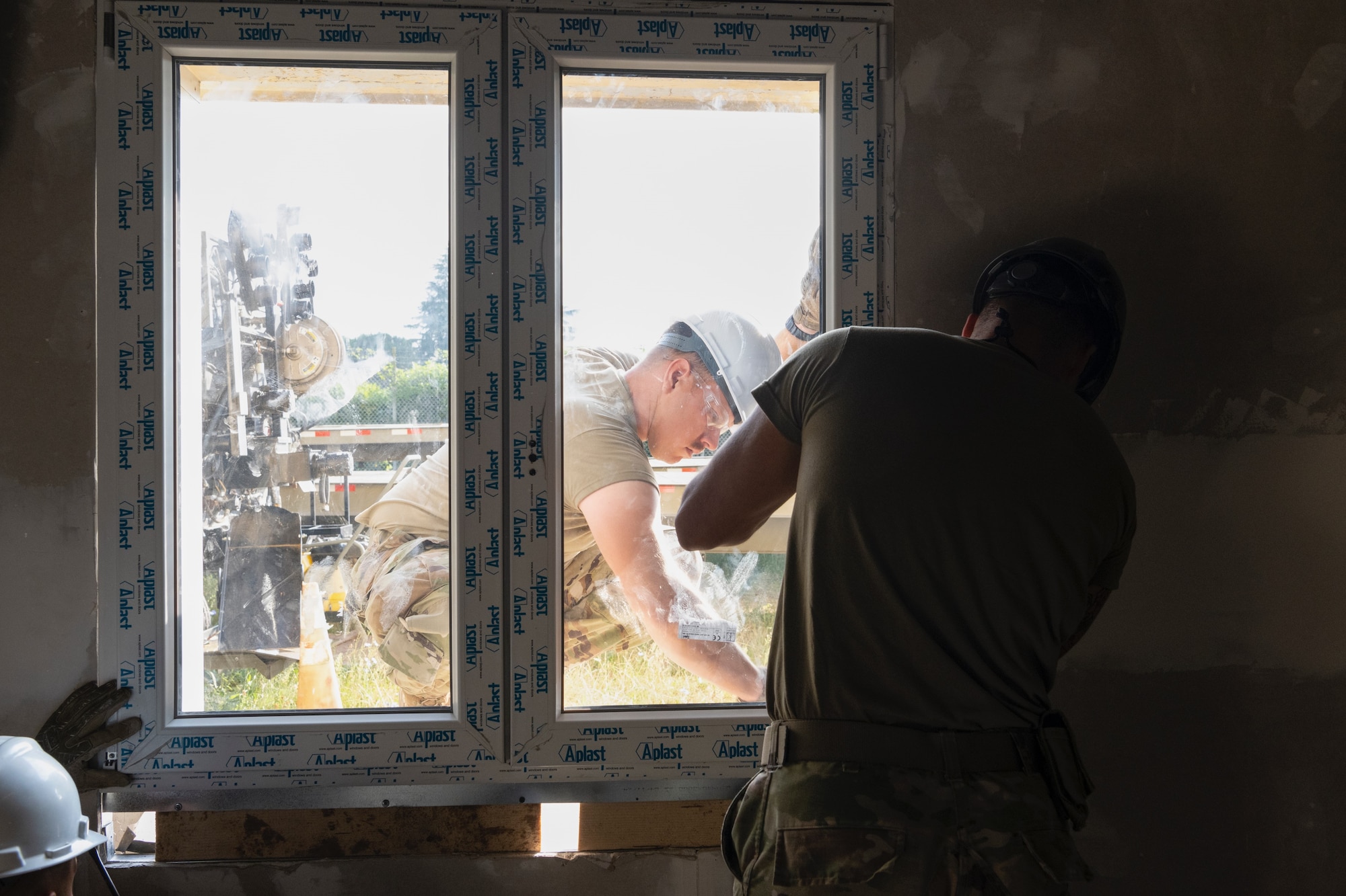 From left, U.S. Air Force Senior Airman Sebastian Rivera, and Senior Airman Wilfredo Ortega, both structural journeymen assigned to the 156th Civil Engineer Squadron, Puerto Rico Air National Guard, adjust a window frame during a Deployment for Training (DFT) at Aviano Air Base, Italy, June 23, 2025. During the DFT, the 156th CES developed their skill proficiency in a new area of responsibility while supporting real-world projects that support the U.S. European Command operations. (U.S. Air National Guard photo by Senior Airman Victoria Jewett)