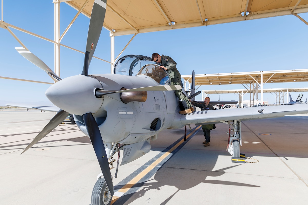 Major Mateusz Borek, flight sciences assistant department chair and chief A-29 test pilot for the Air Force Test Pilot School, prepares for a training sortie at Edwards Air Force Base, California. The A-29C Super Tucano fleet has begun formal integration into school's curriculum. This new aircraft provides students with a modern platform for instruction in aerial spins, sensors and mission systems training, while also giving the school an additional aircraft type for data collection during research projects. (Air Force photo by Jennifer Healy)