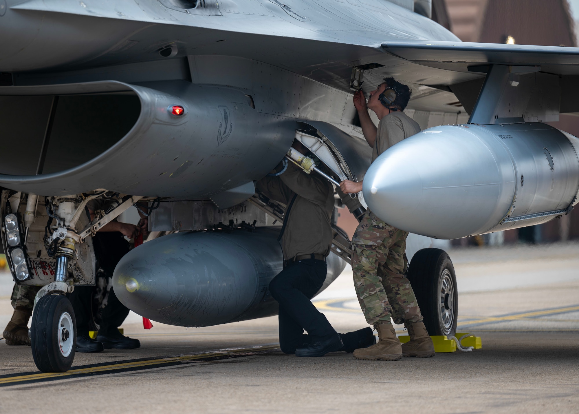 U.S. Air Force Senior Airman Rowley Corbin, 25th Fighter Generation Squadron F-16 Fighting Falcon assistant dedicated chief, inspects an F-16 assigned to the 13th Fighter Squadron at Osan Air Base, Republic of Korea, June 26, 2025. The F-16s were transferred from Misawa Air Base, Japan and have undergone a series of avionics system upgrades, bringing the aircraft closer to fifth-generation capabilities as they increase both the survivability and accuracy of the weapon system. (U.S. Air Force photo by Staff Sgt. Sarah Williams)
