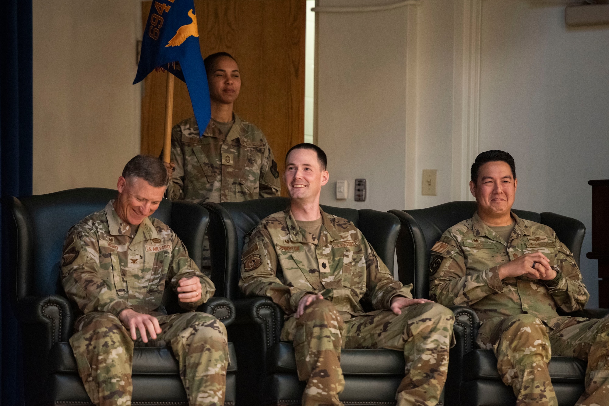 U.S. Air Force Col. Douglas Mabry, left, 694th Intelligence, Surveillance, and Reconnaissance Group commander, Lt. Col. Daniel Johnston, center, outgoing 694th Intelligence Support Squadron commander, and Maj. Albert Yin, right, incoming 694th ISS commander, laugh during the 694th ISS Change of Command ceremony at Osan Air Base, Republic of Korea, July 8, 2025.