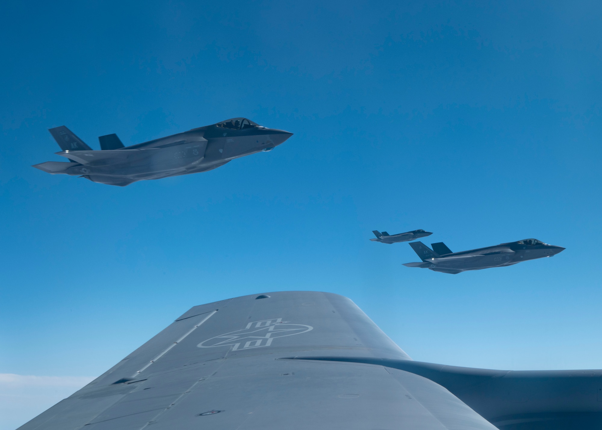 Three F-35 fighter aircraft fly