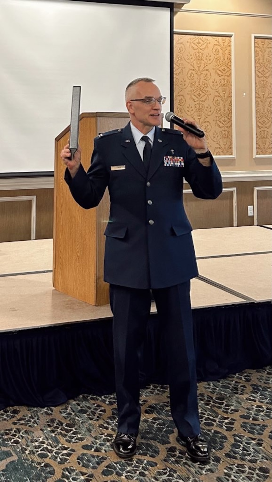 Airmen gives a speech with a microphone. (Courtesy Photo)