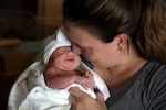 Mother holds newborn baby