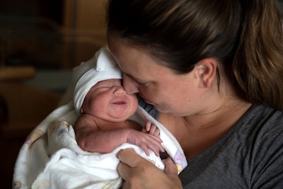 Mother holds newborn baby