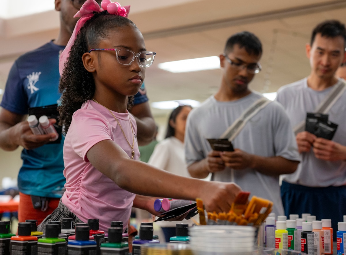 Airmen and their families customize shoes with the Los Angeles-based custom footwear company, Shoe Surgeon, during Operation Sole at JBSA-Fort Sam Houston, Texas, June 14.