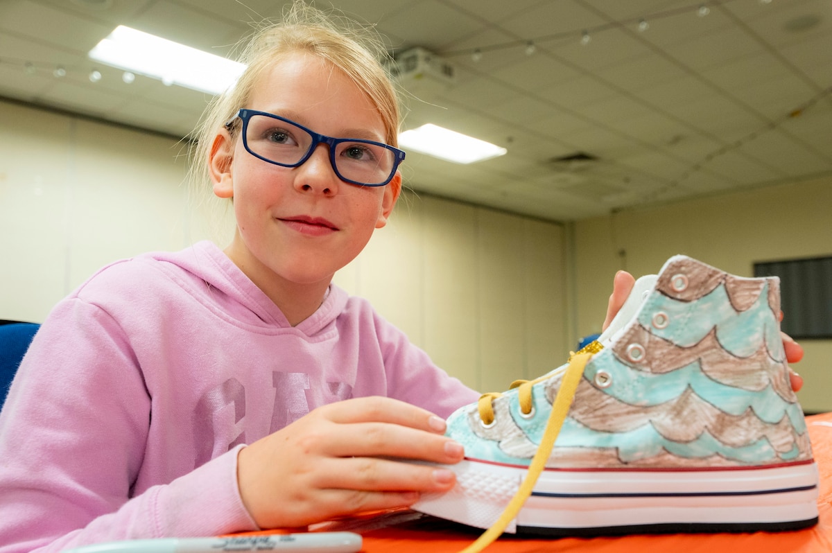 Gwen Dixon customizes a pair of shoes during Operation Sole at JBSA-Fort Sam Houston, Texas, June 14.