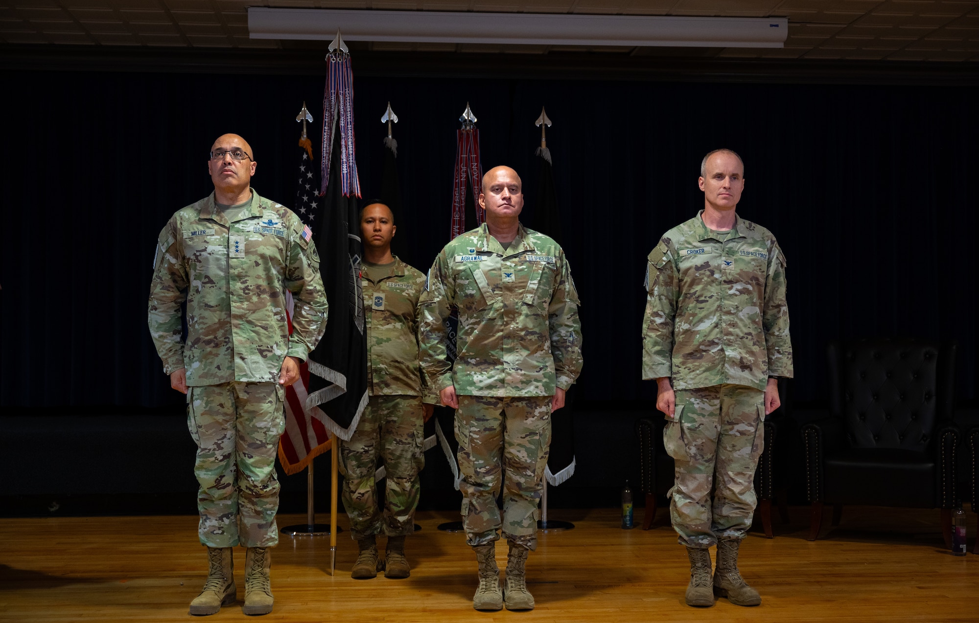 U.S. Space Force Lt. Gen. David N. Miller, Jr., commander of Space Operations Command, U.S. Space Force Col. Raj Agrawal and U.S. Space Force Barry Coker stand at attention as Col. Agrawal prepares to relinquish command of Mission Delta 2 to Col. Croker during a change-of-command ceremony, July 3, 2025, at Peterson SFB, Colo. MD2 conducts Space Domain Awareness (SDA) operations to identify, characterize, and exploit opportunities and mitigate vulnerabilities in the national security space terrain on behalf of the United States Space Force and United States Space Command.