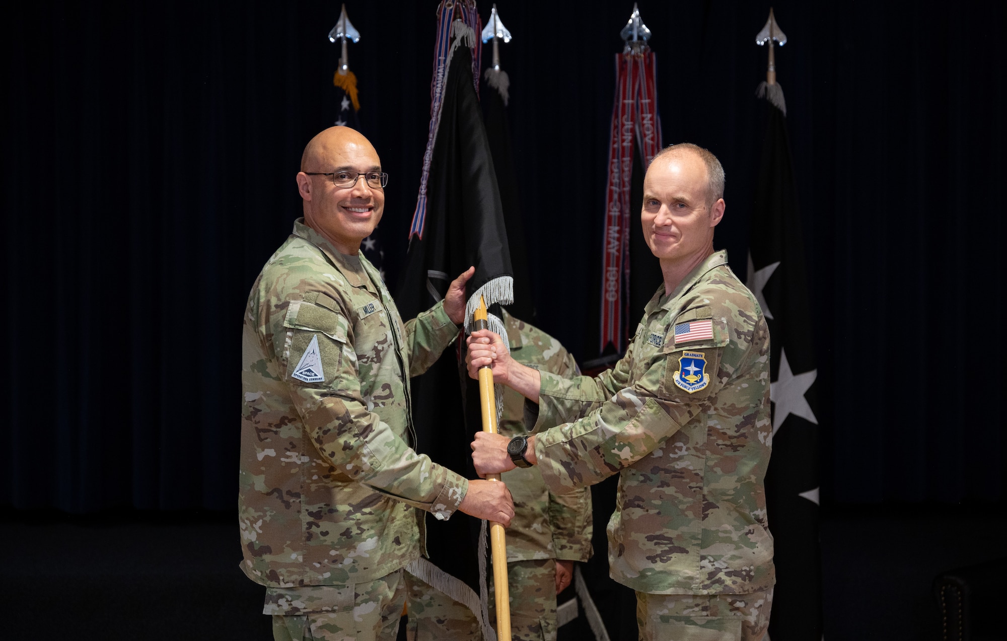 U.S. Space Force Lt. Gen. David N. Miller, Jr., commander of Space Operations Command passes the guidon to U.S. Space Force Col. Barry Croker as he accepts command of Mission Delta 2 during a change-of-command ceremony, July 3, 2025, at Peterson SFB, Colo. MD2 conducts Space Domain Awareness (SDA) operations to identify, characterize, and exploit opportunities and mitigate vulnerabilities in the national security space terrain on behalf of the United States Space Force and United States Space Command.