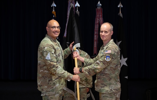  U.S. Space Force Lt. Gen. David N. Miller, Jr., commander of Space Operations Command passes the guidon to U.S. Space Force Col. Barry Croker as he accepts command of Mission Delta 2 during a change-of-command ceremony, July 3, 2025, at Peterson SFB, Colo. MD2 conducts Space Domain Awareness (SDA) operations to identify, characterize, and exploit opportunities and mitigate vulnerabilities in the national security space terrain on behalf of the United States Space Force and United States Space Command.