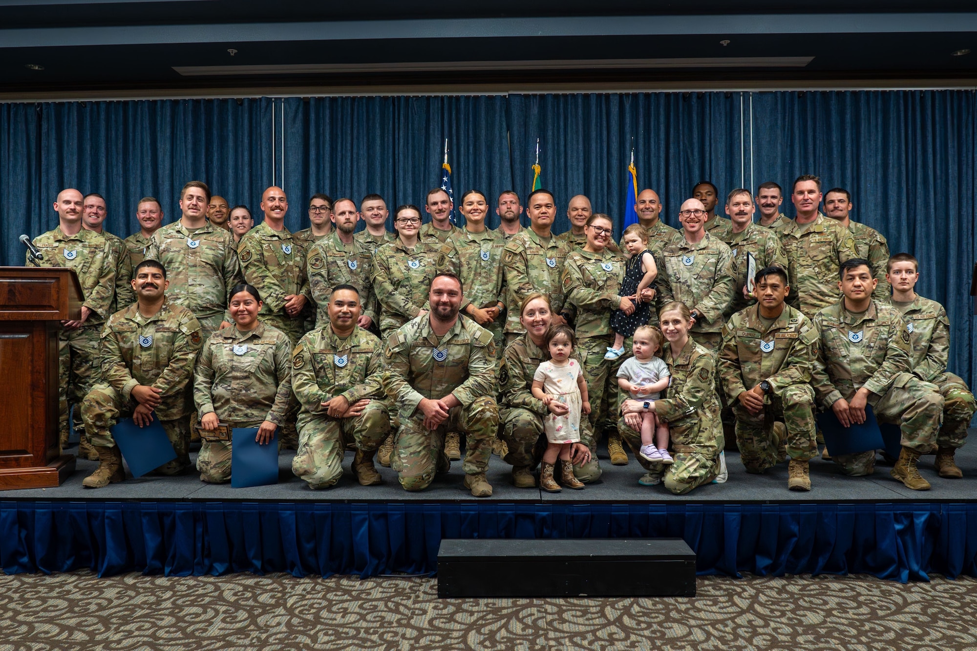 U.S. Air Force 92nd Air Refueling Wing staff sergeants and family members gathered on stage for a group photo during a technical sergeant release ceremony at Fairchild Air Force Base, Washington, July 1, 2025. The event was held to celebrate Fairchild’s Airmen who were selected for promotion to technical sergeant. (U.S. Air Force photo by Senior Airman Morgan St Marks)