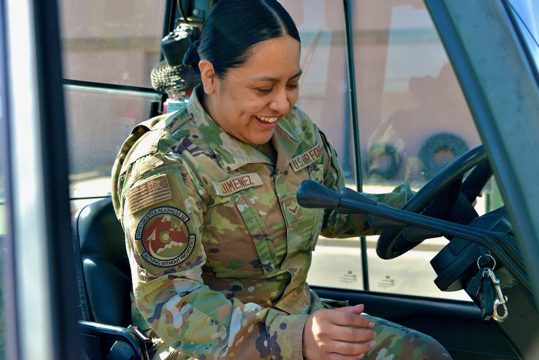 Airmen working in logistics, driving a forklift.