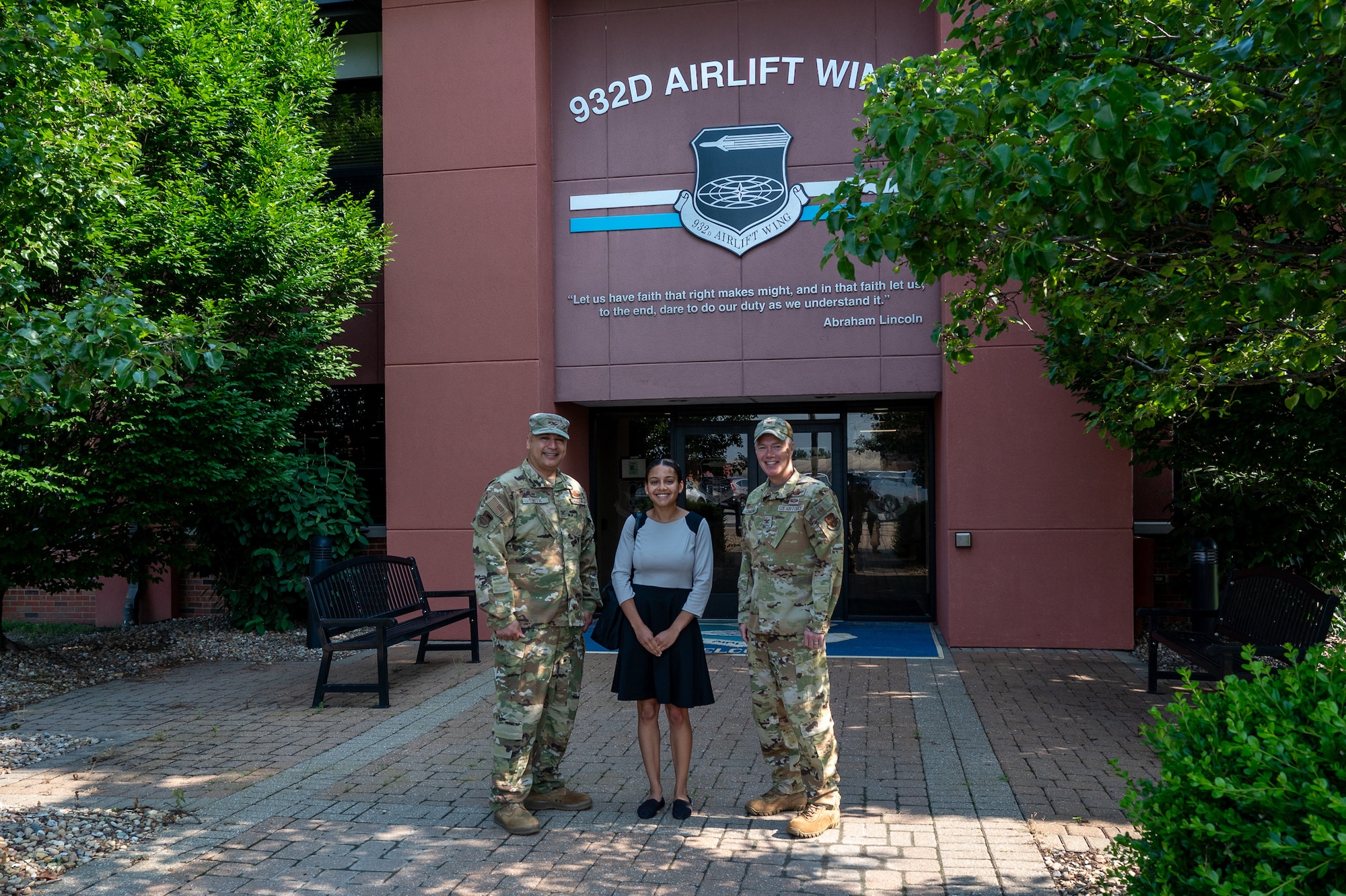 Jenn Atanasov (center), Office of the Senator Tammy Duckworth metro east community outreach coordinator, poses for a photo with Col. Jeffrey Smith 932nd Airlift Wing commander (left) and Col. Rick Chadwick (right), 932nd AW deputy commander in front of the 932nd AW headquarters building upon the conclusion of her visit, Scott AFB, Illinois, June 11, 2025.  Atanasov represents Senator Tammy Duckworth, a U.S. Senator from Illinois who was elected to the Senate in 2016 after serving two terms as a U.S. House of Representatives congresswoman from 2012 to 2016.
