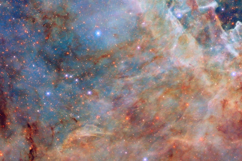 A colorful galaxy in space, which looks like rust and clouds.