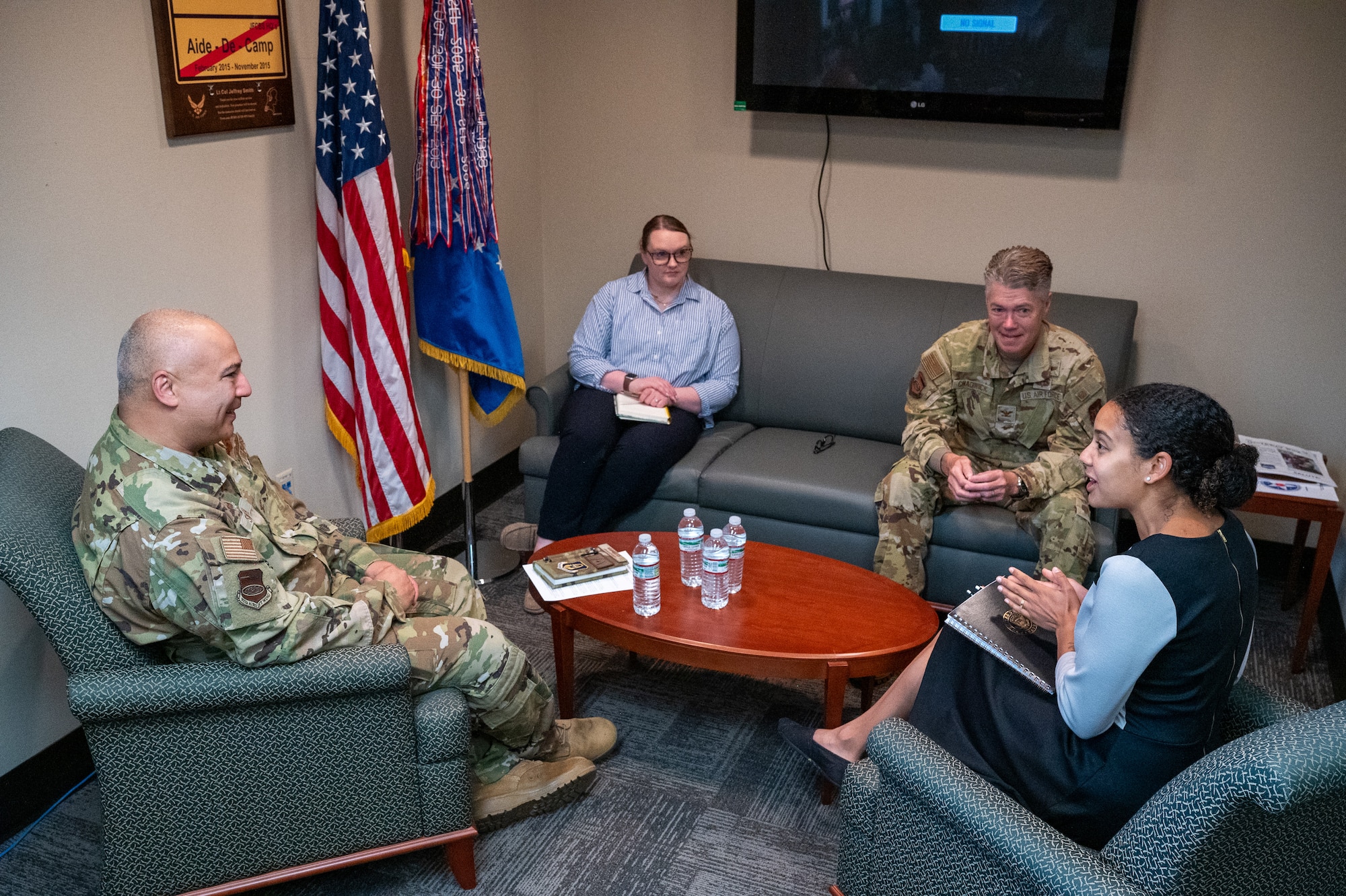 Jenn Atanasov (right), Office of the Senator Tammy Duckworth metro east community outreach coordinator, talks with Col. Jeffrey Smith (left), 932nd AW commander, Col. Rick Chadwick (second from right), 932nd Airlift Wing deputy commander, and Jessica Callahan (second from left), 932nd AW executive officer, June 11, 2025.  Smith and Chadwick discussed recent wing readiness training events, upcoming wing milestones and Air Force Reserve capabilities.