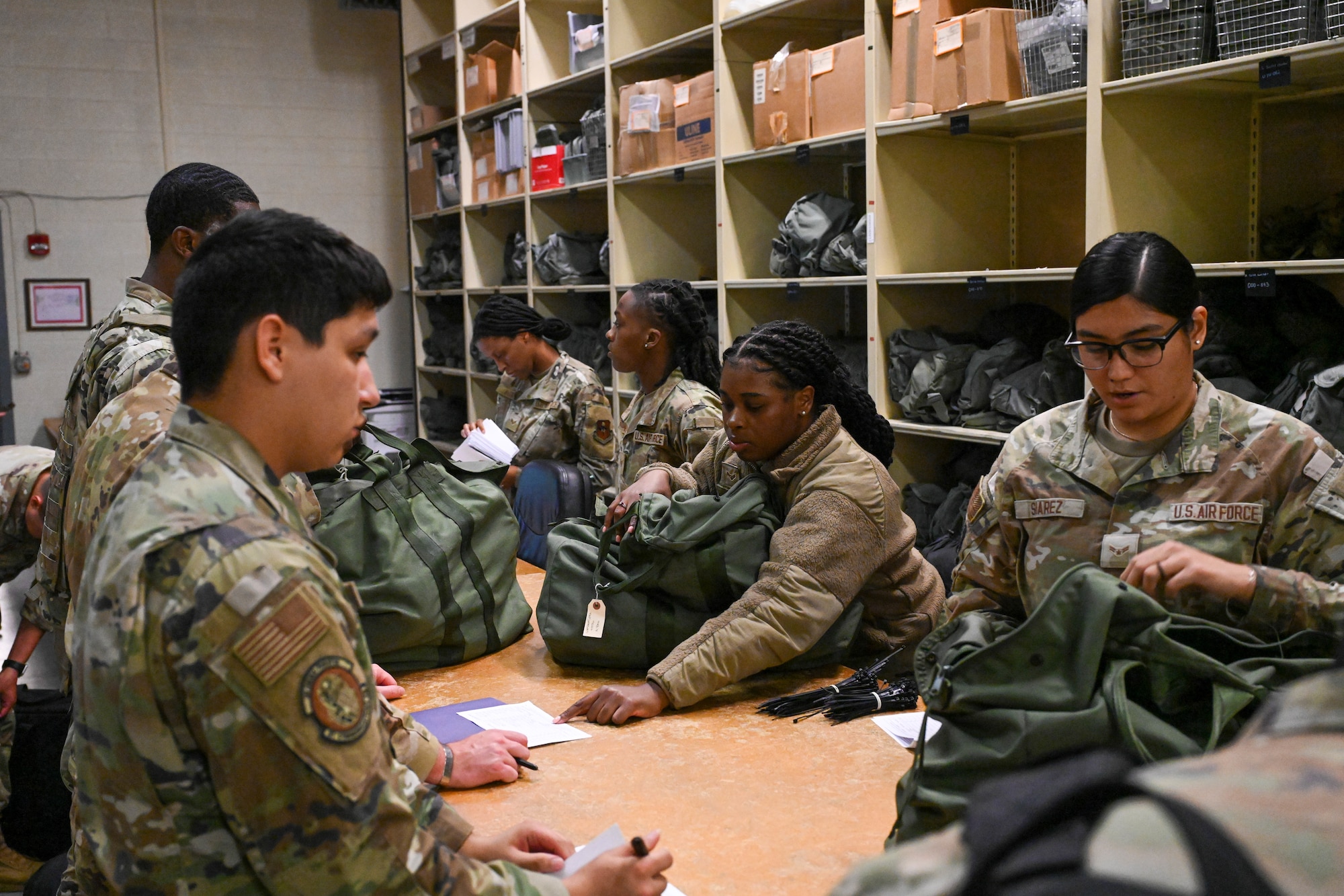 Airmen from the 97th Air Mobility Wing participate in a mass deployment line exercise at Altus Air Force Base, Oklahoma, June 5, 2025. The exercise tested the Wing’s ability to mobilize personnel and equipment in support of global operations rapidly. (U.S. Air Force photo by Airman 1st Class Lauren Torres)