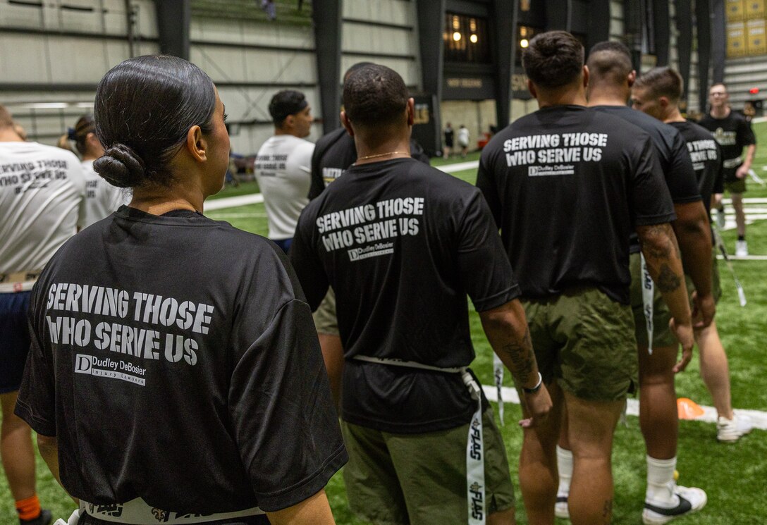 U.S. Marines with Marines Forces Reserve and Marine Forces South form a line to begin dynamic warmups in order to execute the Battle of the Branches tournament at the New Orleans Saints Practice Facility, Metairie, Louisiana, July 1, 2025. The New Orleans Saints hosted the Battle of The Branches for service members from all branches in the U.S. military to come together to participate in a friendly competition. (U.S. Marine Corps photo by Cpl. Aaron TorresLemus)