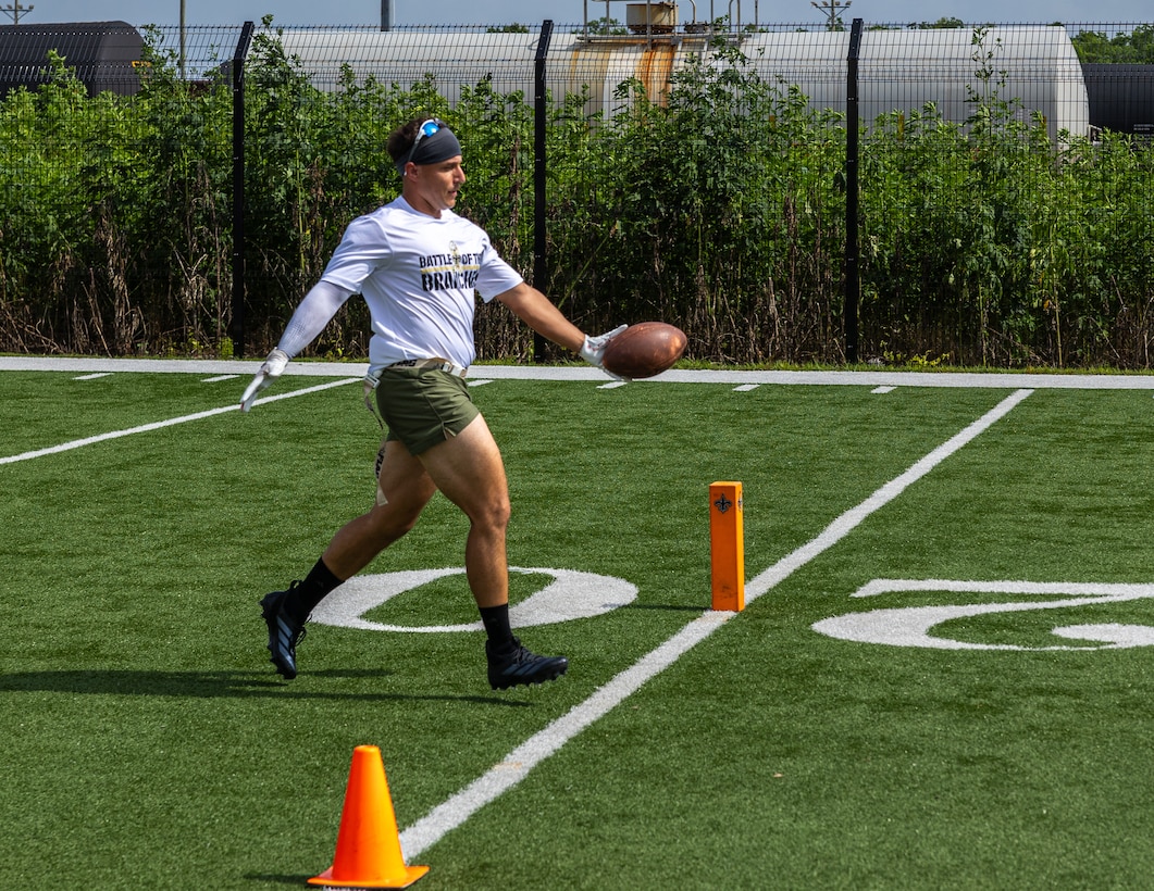 U.S. Marine Corps Staff Sgt. Anthony Gardner, assistant operations and ammunition chief with 4th Marine Division, Marine Forces Reserve, celebrates as he runs through the endzone to score a touchdown during the Battle of The Branches at the New Orleans Saints Practice Facility, Metairie, Louisiana, July 1, 2025. Battle of The Branches consisted of multiple events, the event included flag football, tug-of-war, 40-yard dash, sprint relay, distance throwing and a push up competition. (U.S. Marine Corps photo by Cpl. Aaron TorresLemus)