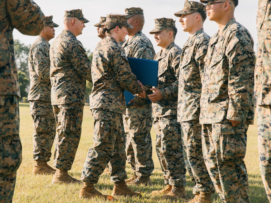 U.S. Marine Corps Lt. Col. Tara E. Patton, the commanding officer of Combat Logistics Battalion 1, Marine Rotational Force – Darwin 25.3, hands out certificates to the battalion’s sailors during a Fleet Marine Force pinning ceremony at Robertson Barracks, Darwin, Australia, July 3, 2025.