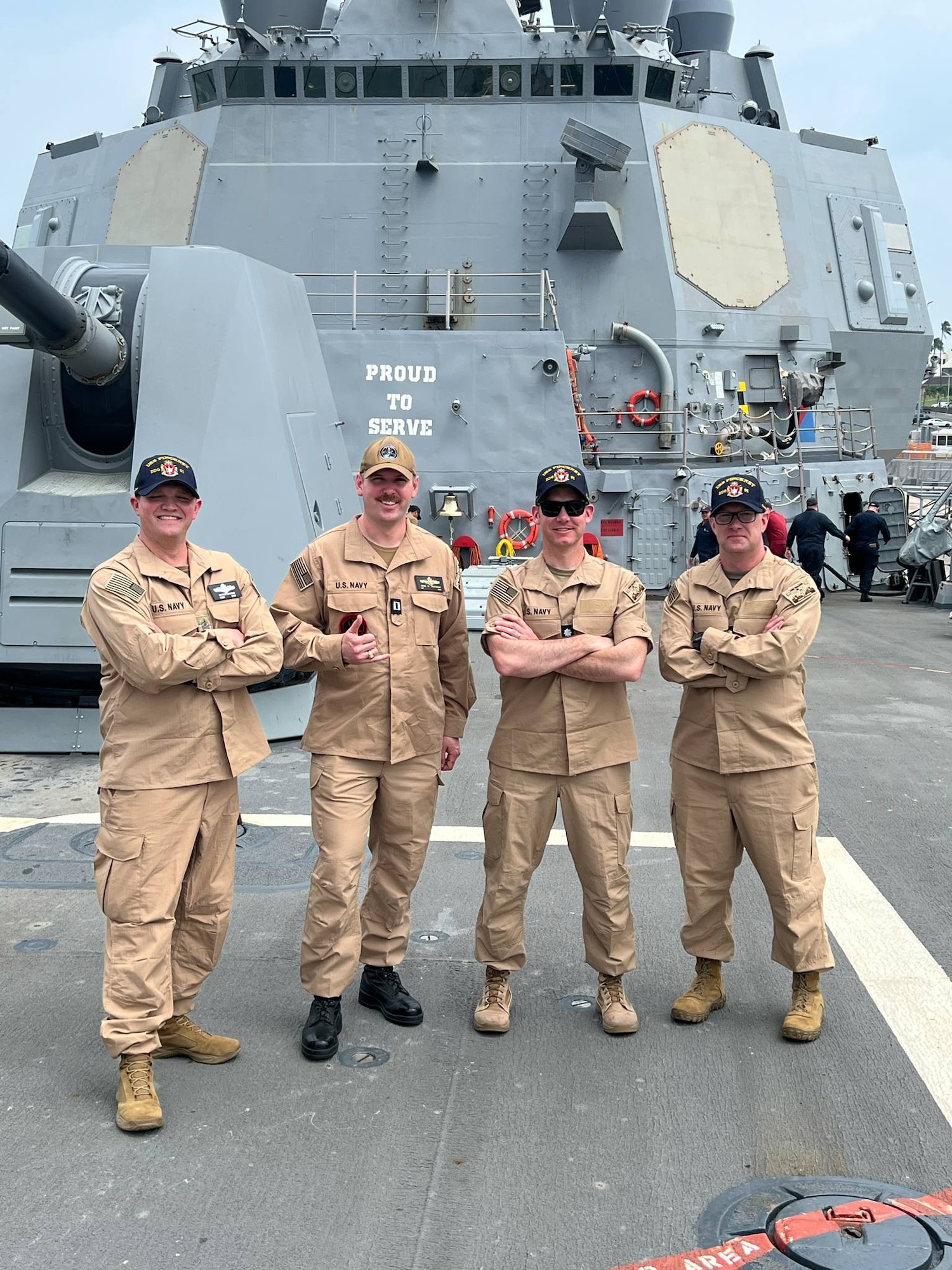 Four men in military uniforms on a ship
