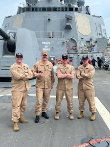 From left, U.S. Space Force Master Sgt. Jeffrey Whitney, National Space Defense Center operations flight chief, U.S. Navy Lt. Tavis McDonald, NSDC deputy operations chief, U.S. Space Force Lt. Col. Daniel Coleman, NSDC director of operations, and U.S. Space Force Maj. Christopher Jackson, NSDC current operations division chief pose for a photo on board the USS Pinckney at Joint Base Pearl Harbor-Hickam, Hawaii, April 6, 2025. The NSDC, in close coordination with the U.S. Navy, successfully completed its third At-Sea Demonstration (ASD-3), further advancing joint capabilities in space domain awareness and ballistic missile defense. (Courtesy photo)
