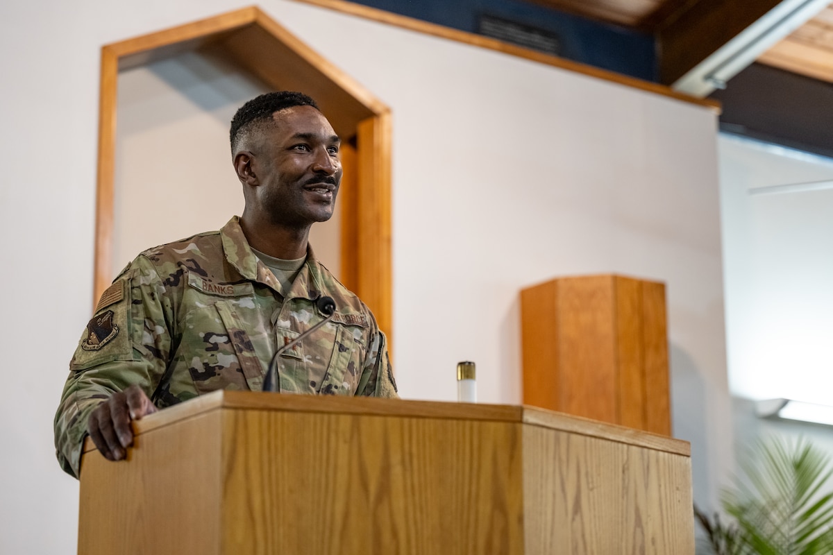 An Air Force service member stands behind a podium