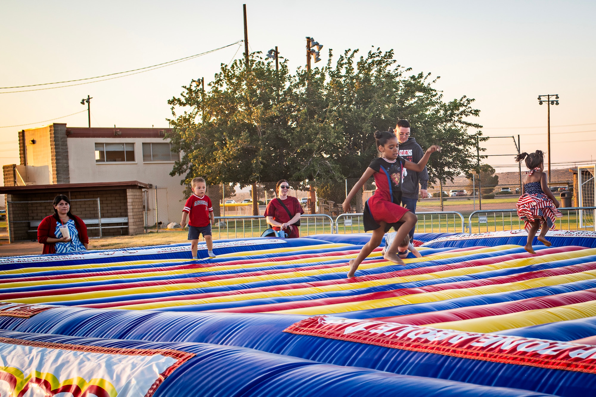 Edwards children run and play on a giant bounce pad at Summer Bash on Edwards Air Force Base, July 4. (Air Force photo by Giancarlo Casem)